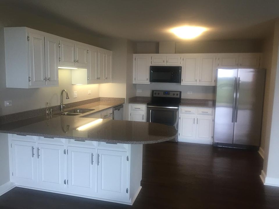 Open plan kitchen with stainless appliances and granite coun
