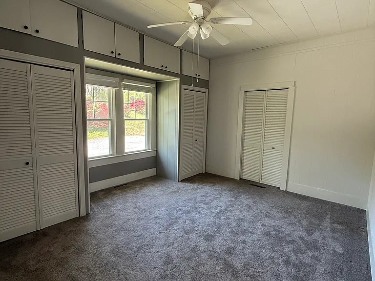 Master Bedroom with large walk-in closet and two additional closets with extra storage areas above