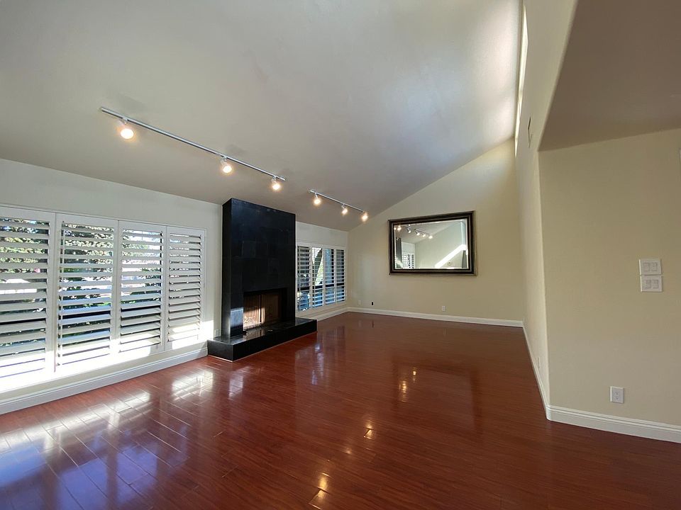 Living Room with wall to wall windows and plantation shutters.