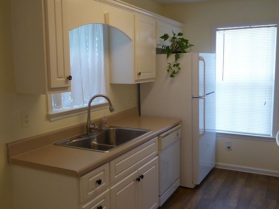 Kitchen with refrigerator, dishwasher, and disposal