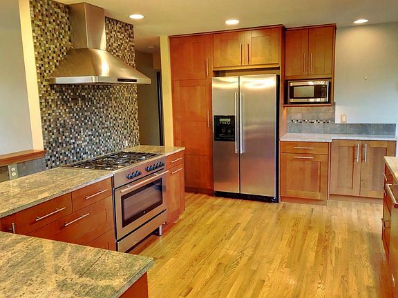 Granite, stainless steel, huge gas cooktop.