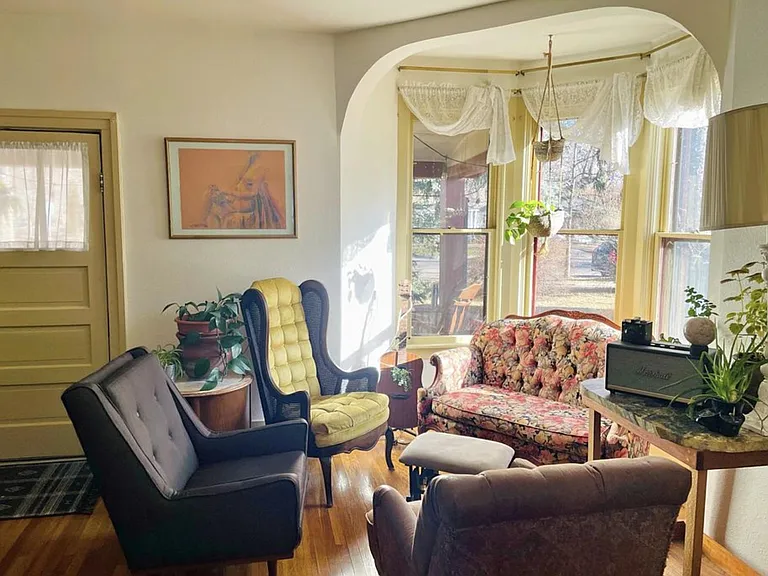 Bay window in living room with front door