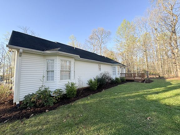 Back of home with wooden deck. This is a wintertime shot.