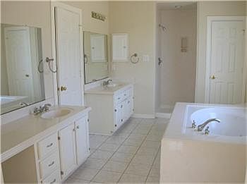 Relax in this master bath with garden tub, separate sinks, walk-in closet