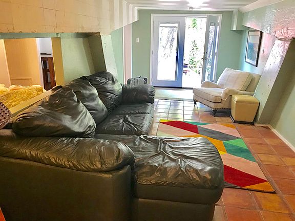 Living room showing French doors to main entrance. Unit is on driveway level. Private entrance.