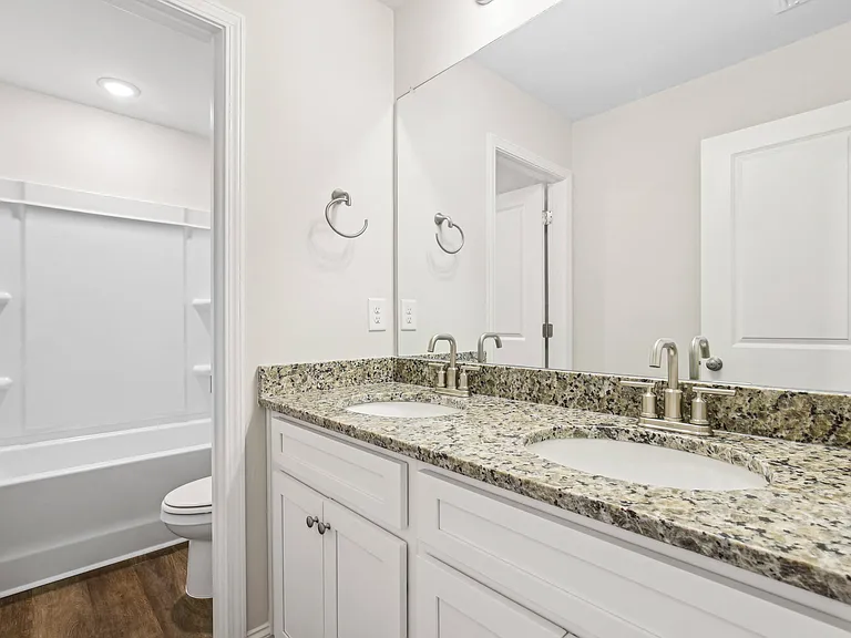 Secondary suite bathroom with a tub and shower combination