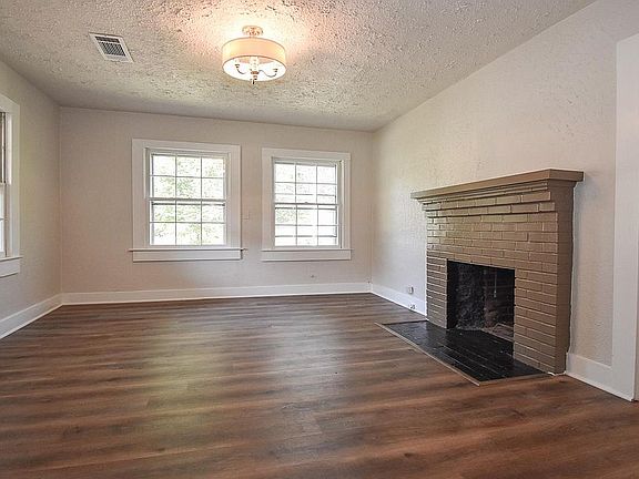 Enter into the living room with REAL WOOD BURNING FIREPLACE and all NEW LUXURY VINYL FLOORING throughout the home!