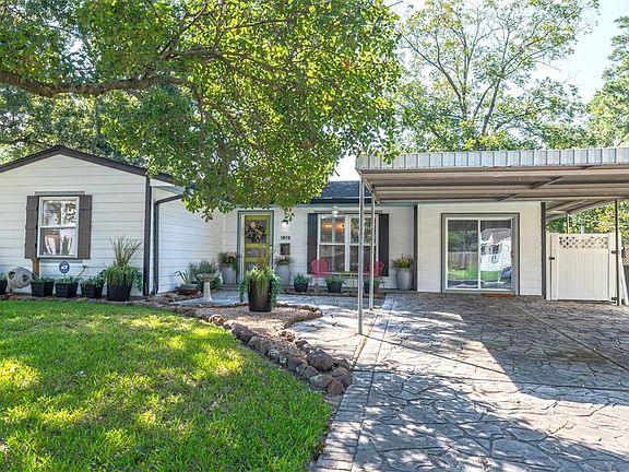 After exiting your vehicle from the protection of your double carport, a masterfully designed front entrance with stamped concrete, covered front porch, double paned windows with custom shutters and an exquisite 4 paneled front door await you and you