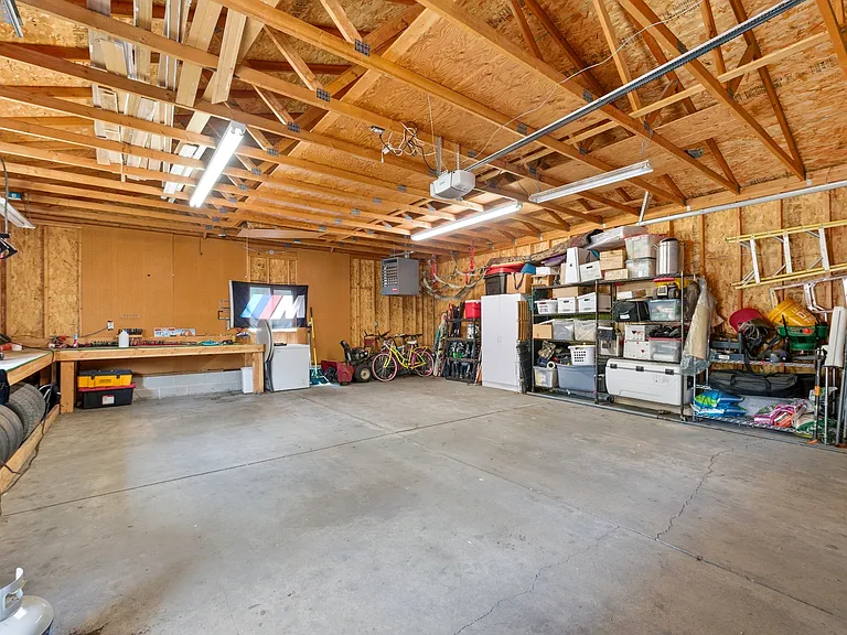 Huge 4 car garage with work bench accessible from the back alley. Additional walkway to the home from here.