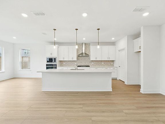 Spacious kitchen with eat-in island photos may depict options and features that aren t available