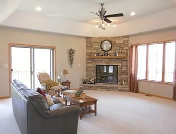 Very spacious living room includes stone fireplace