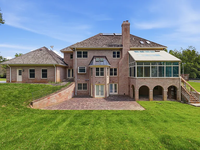 Large rear patio with wooded views.