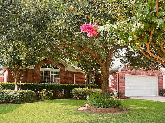 Lush landscape and mature trees in front and back yard.