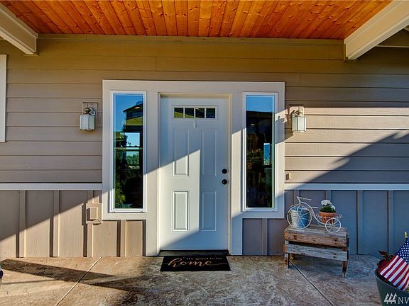 Coved porch at entrance with stamped concrete. 