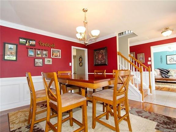 Beautiful Brazilian Hardwood Flooring accent the Formal Dining Room with Chair Rail and Picture Framing.