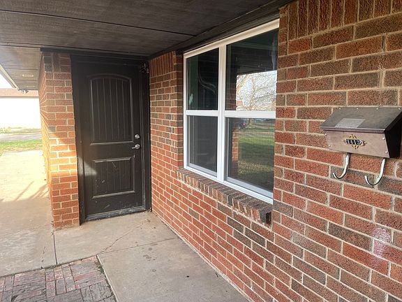Door to garage & Living Room window