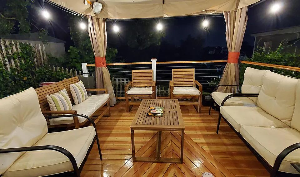 Shared deck area, surrounded by a garden and grill space