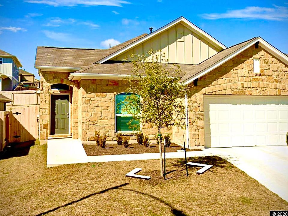 Exterior with beautiful stone masonry, landscaping and well-maintained grass turf.