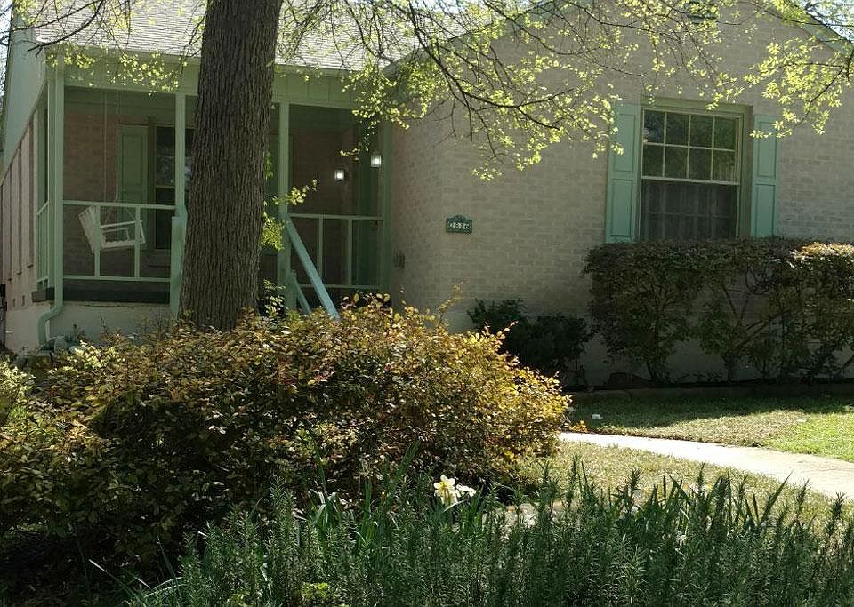 Exterior view of cottage with front porch swing.