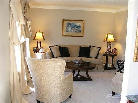 This charming living room is located to the left of the marble foyer