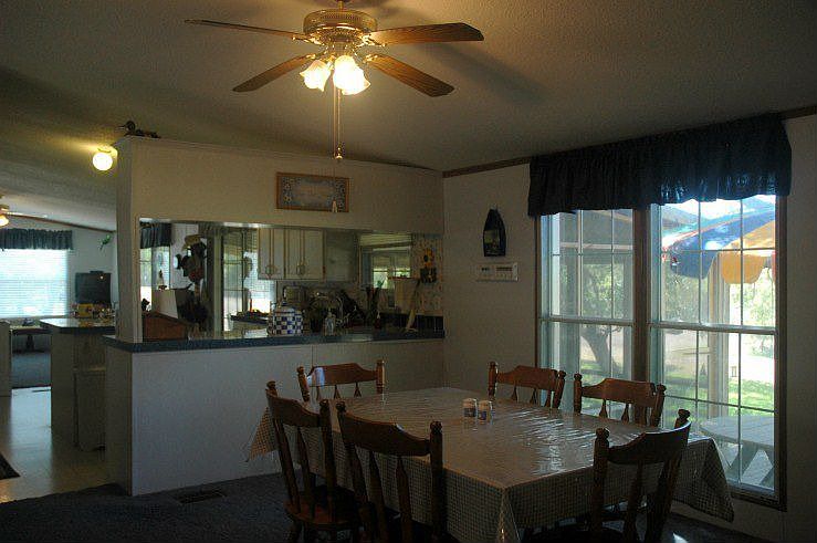 Dining to kitchen and deck in second home.
