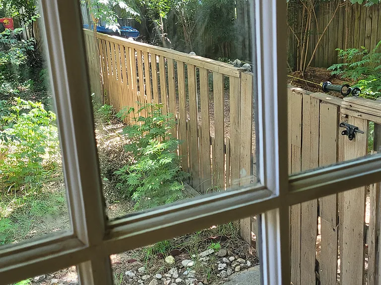 View outside back window at the dog run. Previous dogs would jump out, so a hotwire was installed. Can be connected or disconnected depending on tenant's preference. Have miles of walking trails along the Trinity River and Irving Golf Club.