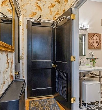 As you enter, the bathroom is to the left and the