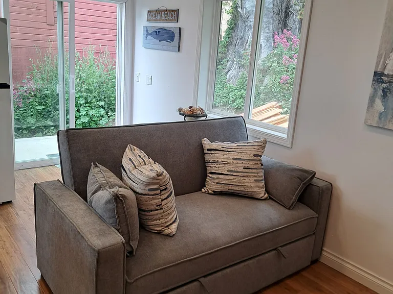Living Room Couch (folds out to bed), Laminate Flooring, Recessed Lighting, Sliding Glass Entrance Door