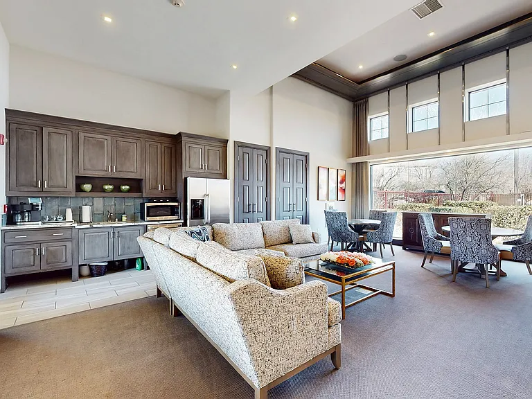 Experience the luxury of expansive windows and chic design in this modern living space.