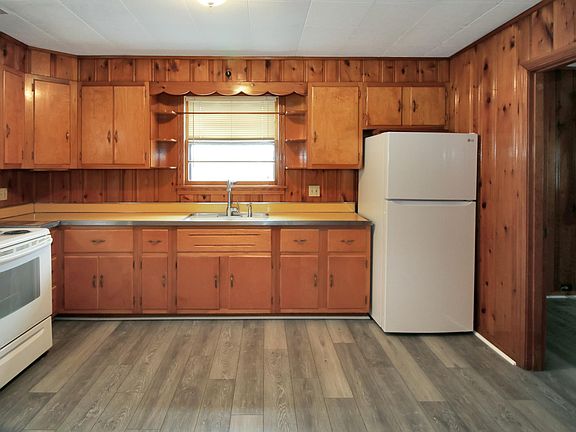 Kitchen includes electric stove and brand new refrigerator. Space for eat-in