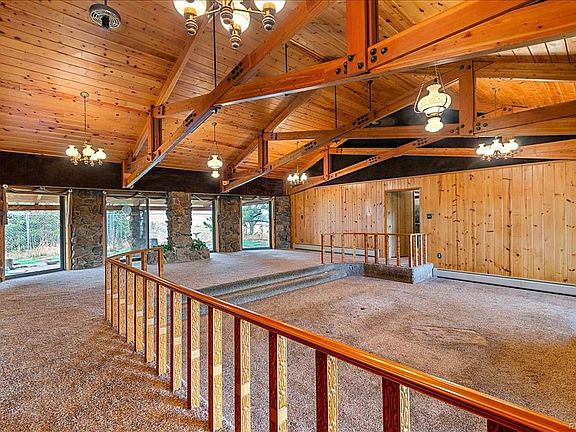 Spacious Great Room, sunken Living Room with Dining area near large windows and patio doors.