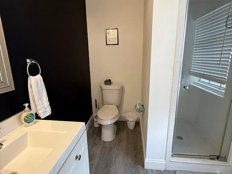 Equipped with essential amenities, mirror, and towel holders.