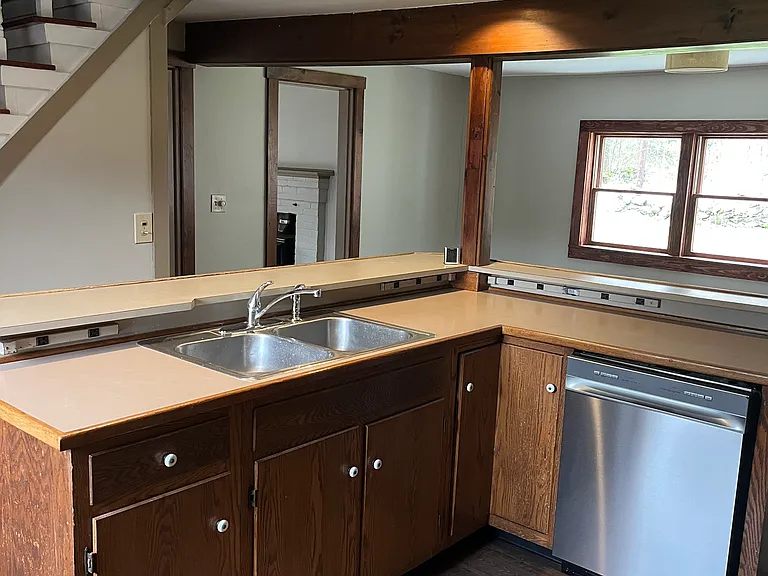 Island with ample counter space, bar, double sink and under counter outlets
