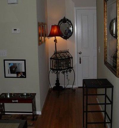 Quaint hallway leads to powder room with pedestal sink, closet with storage and extra wide 2 car gar
