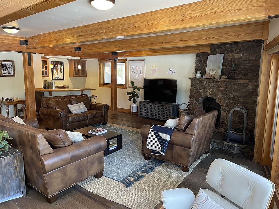 Photo of the living room, fireplace and wet bar. Photo taken from dining room.