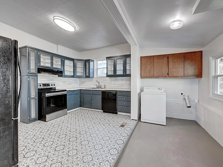 Laundry room is convenient to the kitchen and has room for additional side cabinets, too!