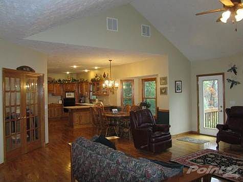 The Living Room opens to the expansive casual dining space and Kitchen; all with gleaming hardwood f