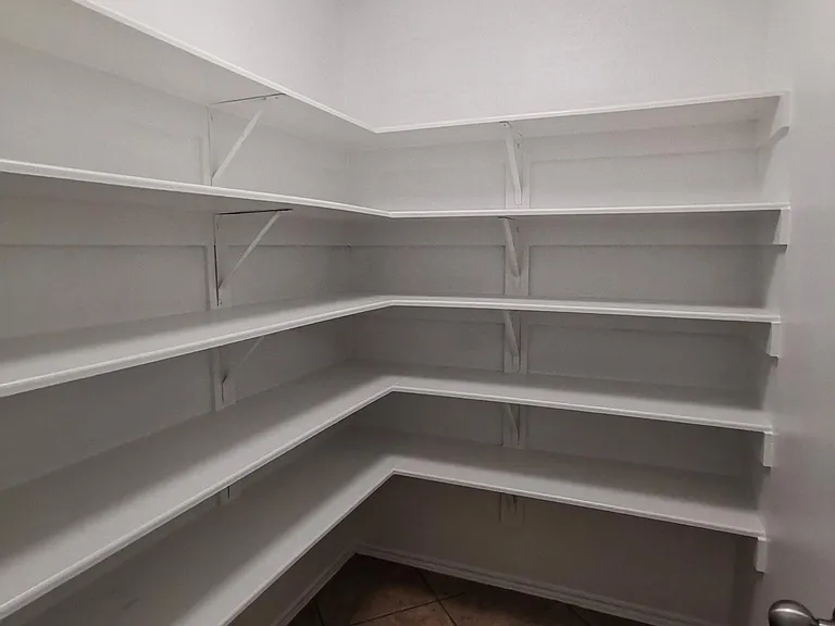 Large walk-in pantry adjacent to kitchen