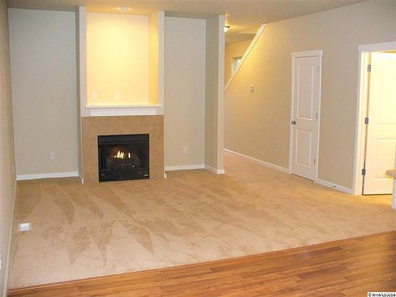 great room opens up to kitchen gas fireplace with slider to back yard