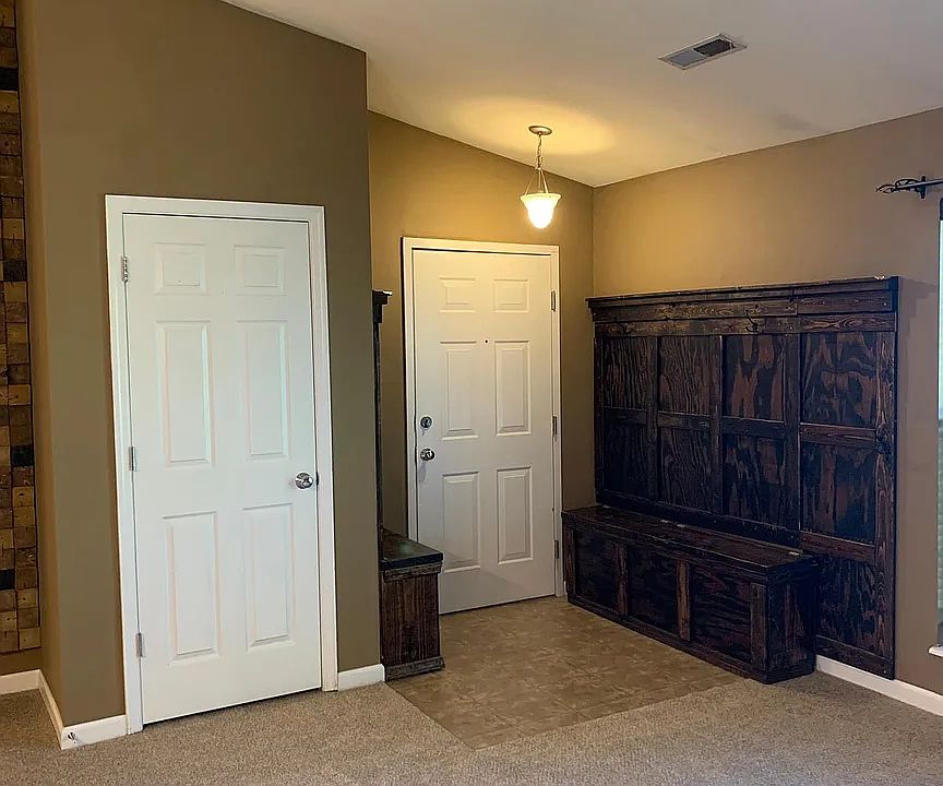 Your entrance has coat hangers, storage, and seating.