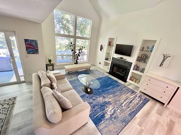 Large windows fill the room with natural light, making it the perfect space for relaxing or entertaining.