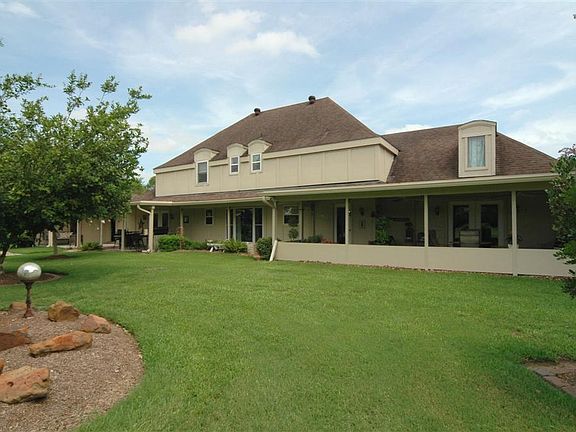 The back of the home offers plenty of spacious covered patio areas for enjoying your outdoor space.