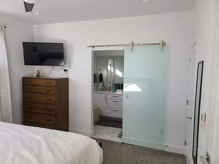 Primary bedroom, primary bath with sliding door. Bathroom has separate toilet room and spacious shower