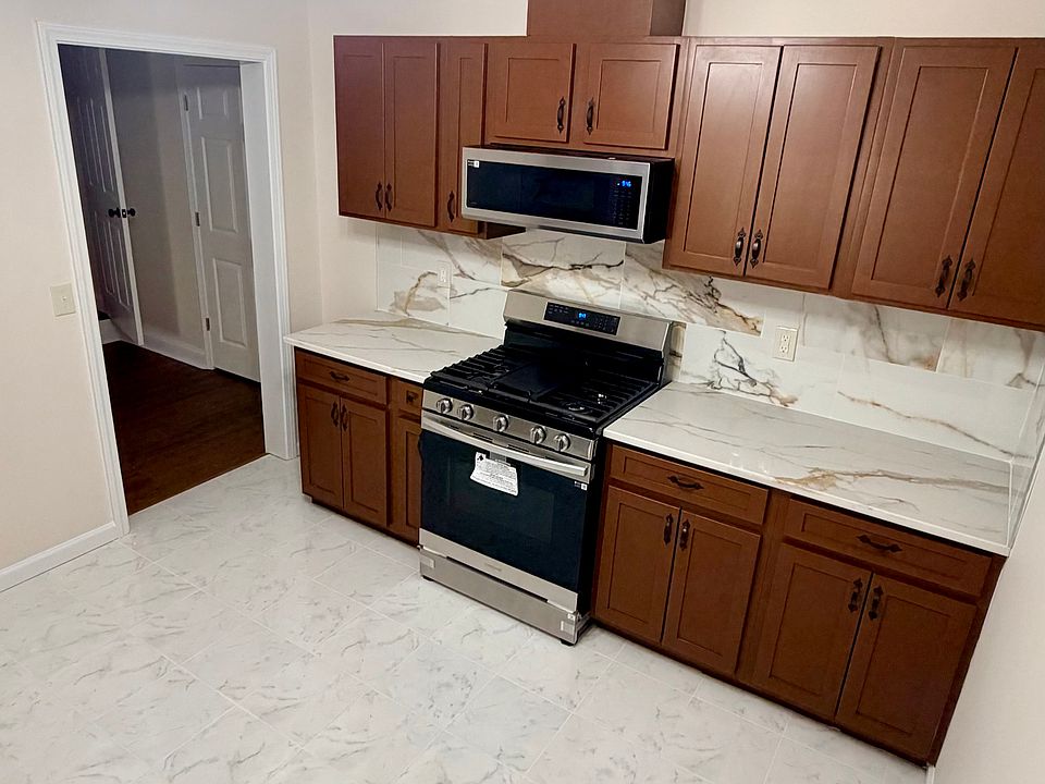 Spacious kitchen with gas stove with grill, oven and microwave