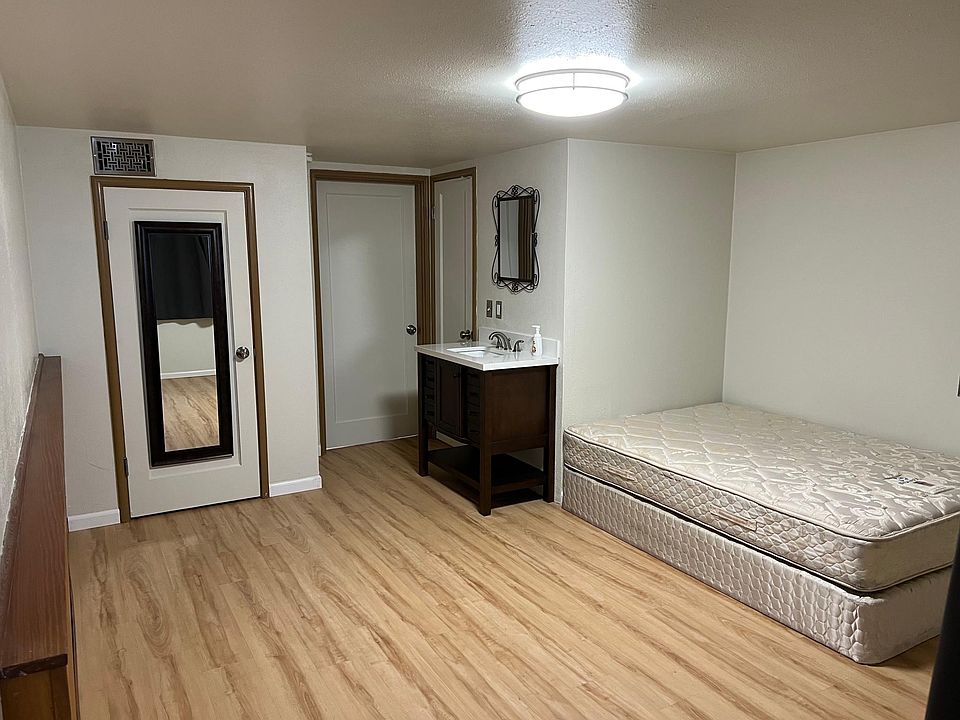 Main studio living space. Door on left to closet, Door in middle to kitchen, Door on right to bathroom. Full/Double mattress available for us, but can be removed upon request.