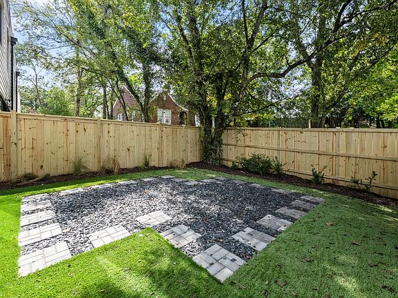 Private fenced in back yard with artificial turf.