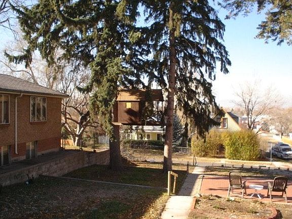 This is looking west, on a clear day -- beautiful mountain views. Note the brick patio and gorgeous, towering pines.