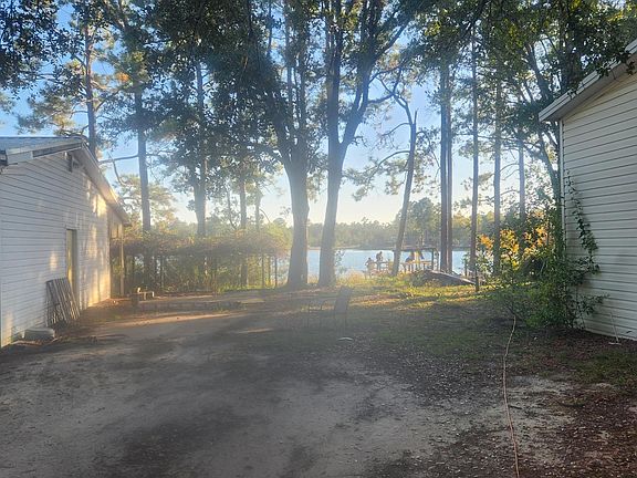 View of lake and the home on right, garage on left.