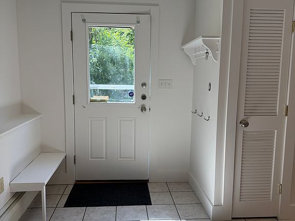 Entrance to apartment. Bench, coat hooks and shelf for easy organization. Pantry/Storage closet.