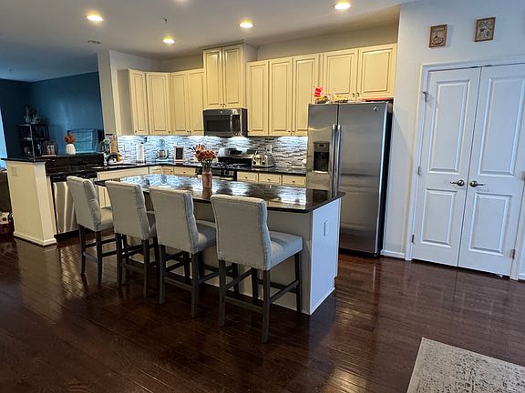 Large Kitchen with stainless steel appliances, seating for 4 at the island, granite counter tops, large pantry and under cabinet lighting.